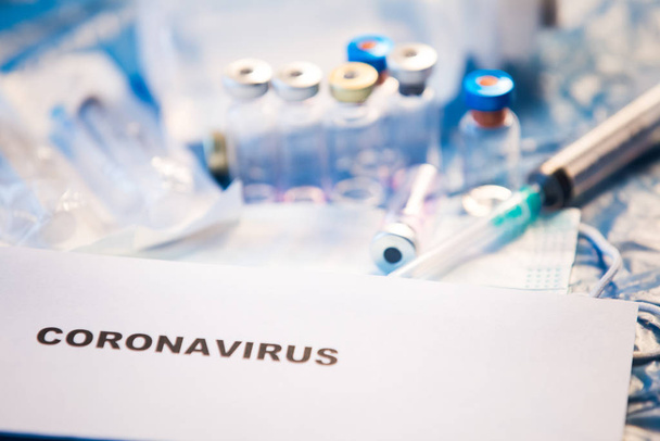 Coronavirus vaccine bottle blue medical background - Foto, imagen