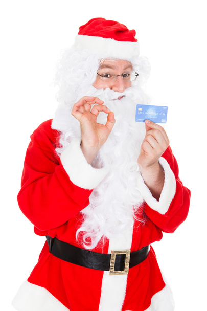 Portrait of santa holding credit card - Foto, Bild