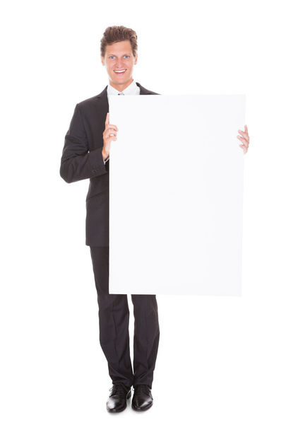 Businessman Holding Blank Placard - Фото, зображення
