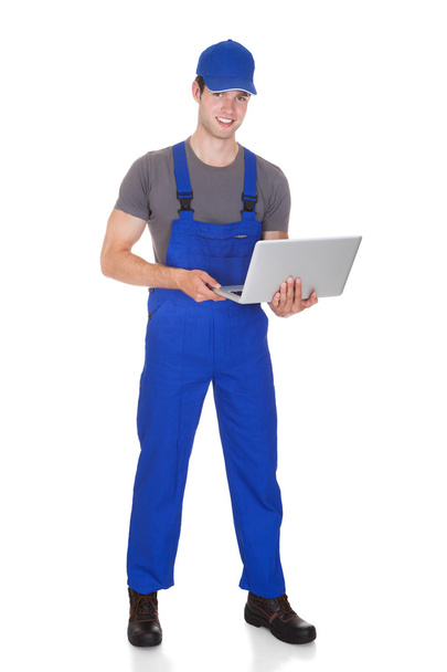 Mechanic Holding Laptop - Фото, изображение