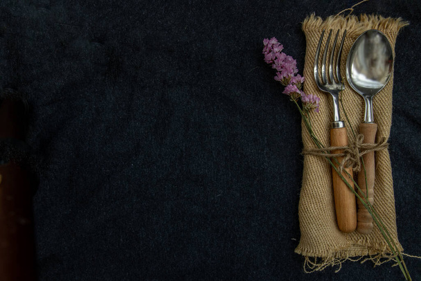 Rustic vintage set of wooden spoon and fork on black background. Top view, Copy space, Selective focus. - Photo, Image