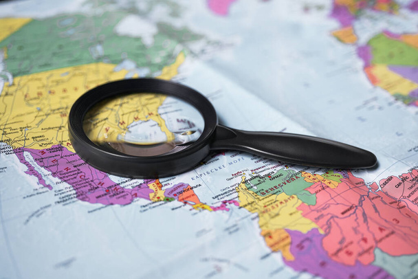 magnifying glass on a world map. Travels. America on the map               - Photo, Image