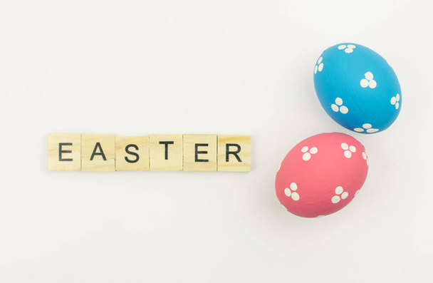 Text wooden blocks spelling the word happy easter on white background - Fotó, kép