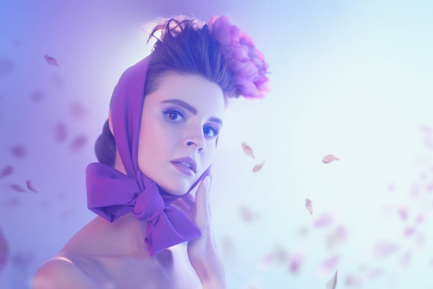 Portrait of a gentle romantic girl with elegant headdress with peony flower in soft purple haze with flower petals. Inspiration of spring. Beauty, fashion. - Φωτογραφία, εικόνα