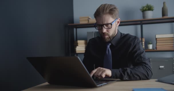 Man in Eyeglasses Working on Laptop in Office - Кадри, відео