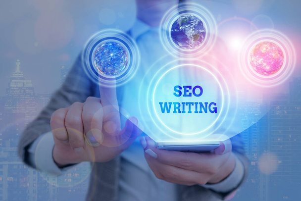 Handwriting text writing Seo Writing. Concept meaning grabbing the attention of the search engines using specific word. - Photo, Image