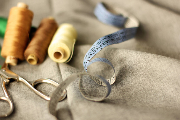 Sewing. Spools of thread on the fabric. Threads. Meter - Фото, изображение