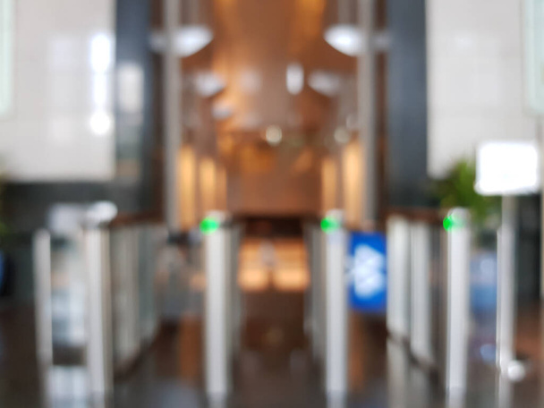Blurred shot of access turnstile to use key card for enter area. In building security only for authorized person. Technology in office workplace help to keep people and property safe and secure. - Photo, Image