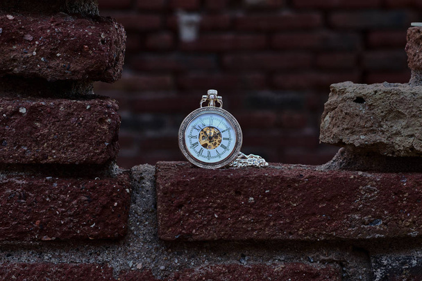 Vintage pocket watch on a red brick wall - Photo, Image