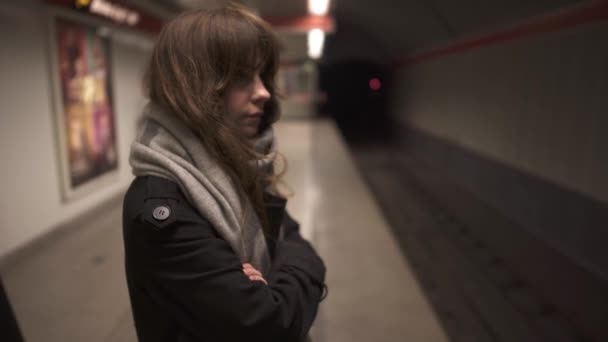 Handheld middle shot of woman standing on metro platform - Footage, Video
