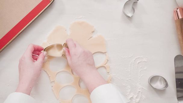Step by step. Flat lay. Cutting sugar cookie dough with Easter shaped cookie cutters. - Photo, Image