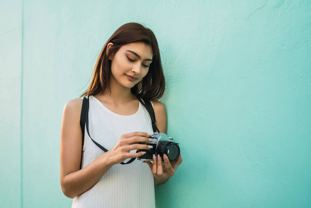 Portrait of young photographer woman using a professional digital camera. Photography concept - Foto, Imagem