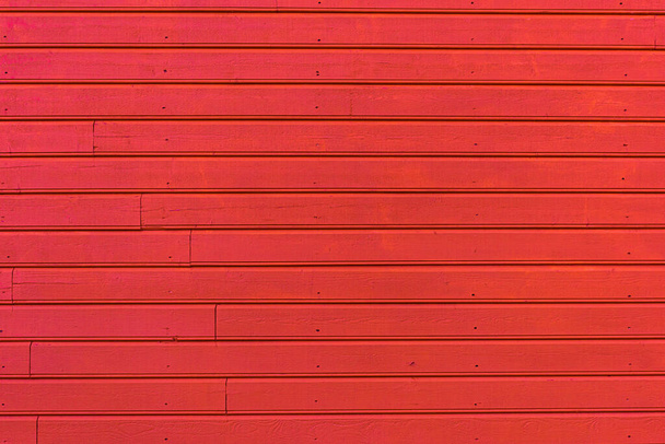 Wooden plank wall painted red. - Fotoğraf, Görsel