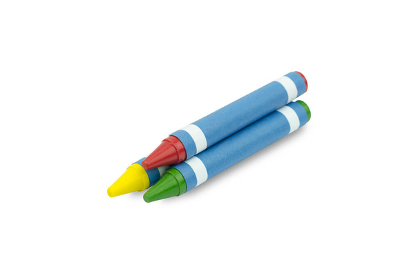 Красно-зеленый и желтый восковые карандаши на белом фоне
 - Фото, изображение