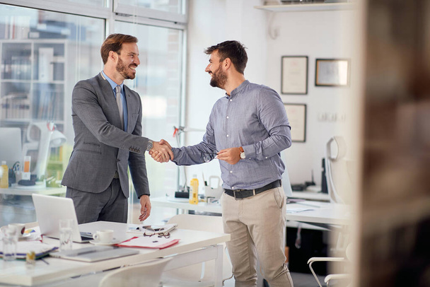  Smiling business people at meeting handshake.  Successful  meeting  - Foto, afbeelding