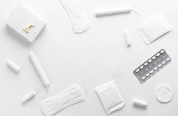 Tampons, feminine sanitary pads on a white background. Hygienic care on critical days. menstrual cycle. Caring for womens health. Monthly protection. Flat lay, top view, copy space - Φωτογραφία, εικόνα
