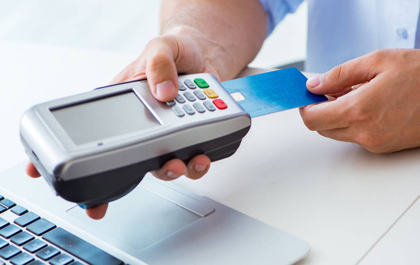 Man processing credit card transaction with POS terminal - Photo, Image