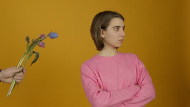 Offended girl standing with crossed arms and ignoring flowers - Footage, Video