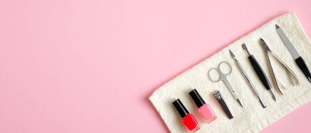 Manicure and pedicure tools on pink background. Top view with copy space. Nail salon banner design template. Beauty treatment concept - Fotoğraf, Görsel