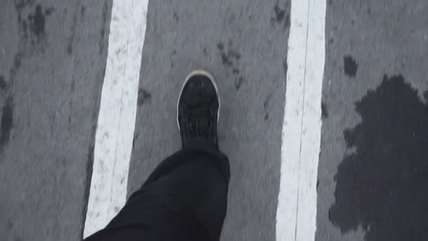 wandelen op nat asfalt voetpad concept van vrijheid. gaat kijken naar beneden in sneakers - Video
