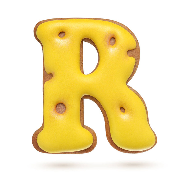Großbuchstabe R gelber selbstgebackener Lebkuchen isoliert auf weißem Hintergrund. - Foto, Bild