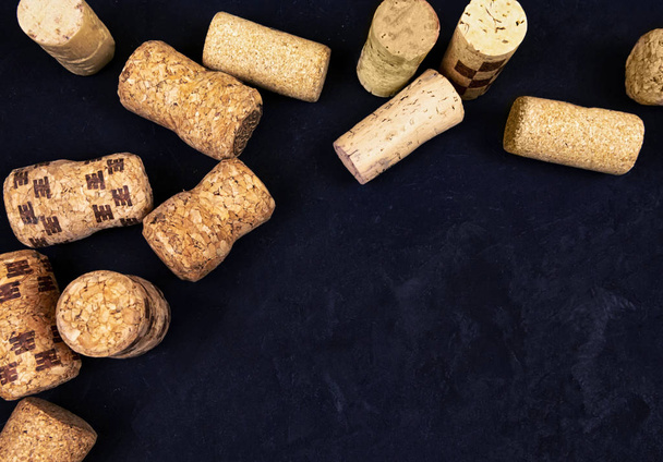 wine corks on a black textured surface. top view. place for text - Photo, Image