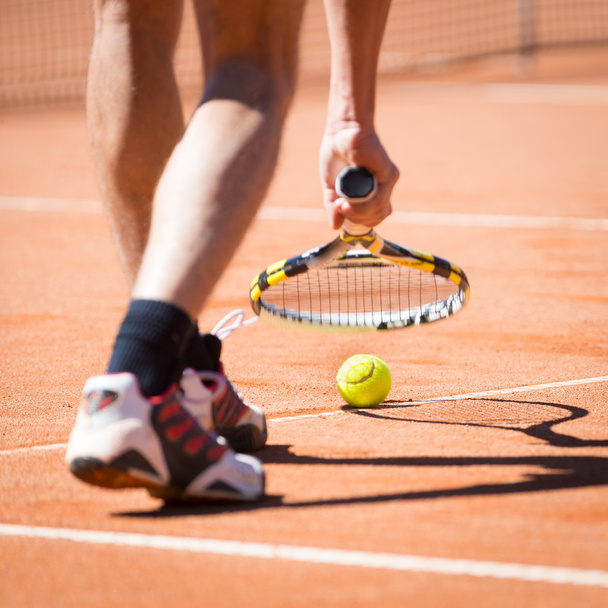 Sportsman catchs up his tennis ball with racket - Fotografie, Obrázek