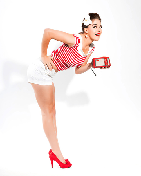 Sexy retro pin-up girl with radio and red lipstick wearing red s - Φωτογραφία, εικόνα