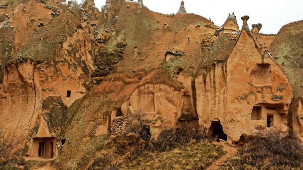 Cave houses and monasteries carved into Tufa Rocks at Zelve Open Air Museum (Zelve Valley) in winter season in Cappadocia, Turkey - Zdjęcie, obraz