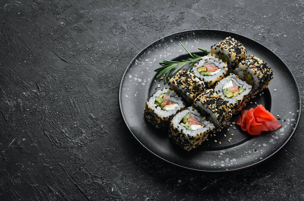 Sushi Rolls - California with sesame, salmon and avocado. Set of sushi rolls of seafood - Zdjęcie, obraz