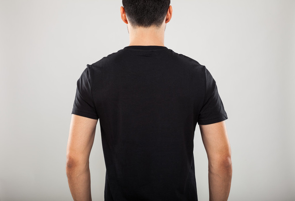 Back of man wearing a black t-shirt - Fotoğraf, Görsel