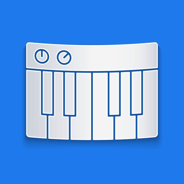 Иконка музыкального синтезатора вырезана на синем фоне. Электронное пианино Бумажный стиль. Векторная миграция
 - Вектор,изображение