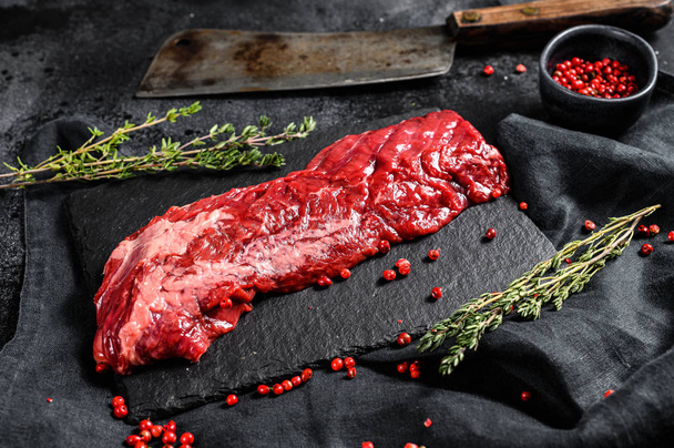 Raw skirt, machete steak with pink pepper and thyme. Black background. Top view. - Photo, Image