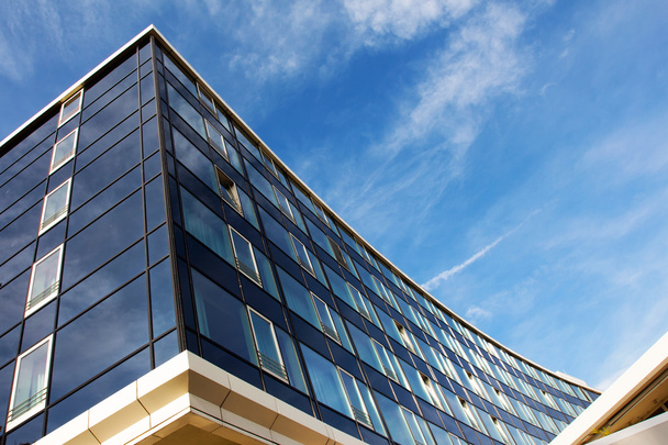 Modern glass architecture against the blue sky - Fotó, kép