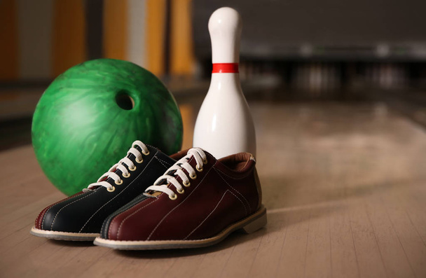 Pin, shoes and ball on alley in bowling club. Space for text - Foto, immagini