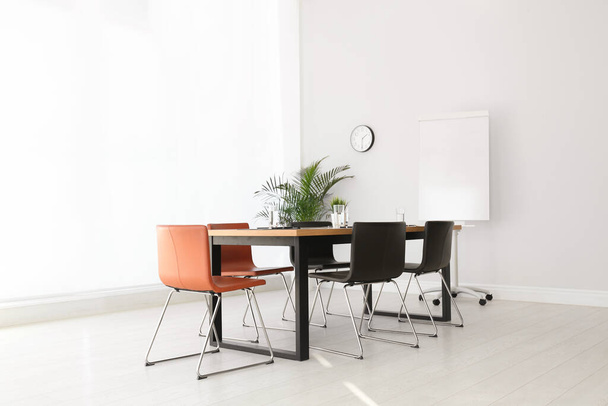 Simple office interior with large table and chairs - Fotó, kép
