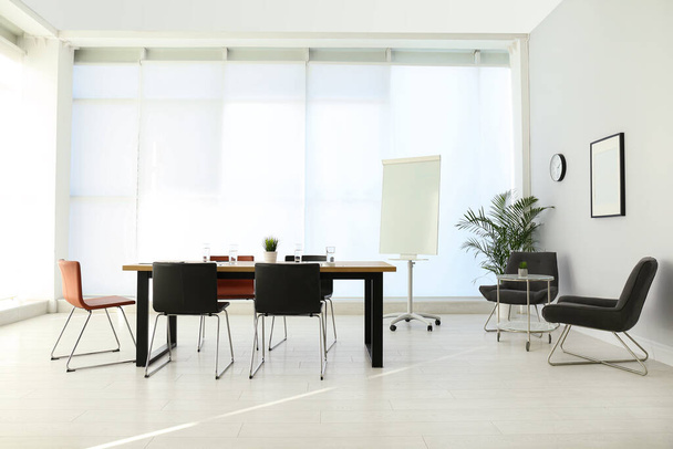Simple office interior with large table and chairs - 写真・画像