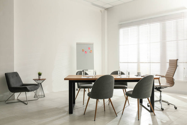 Simple office interior with large table and chairs - Fotó, kép