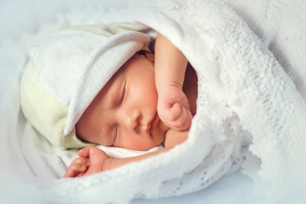 Close up of cute newborn baby taking nap on white lace sheets. Sweet child resting in shelf in the dresser. Concept of sleeping infant. - Valokuva, kuva