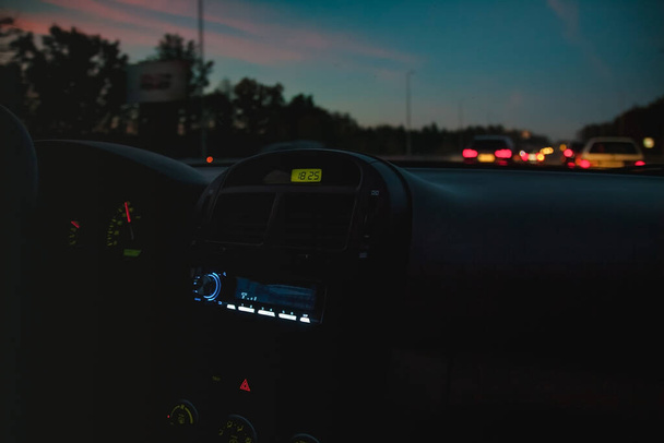 Torpedo in the car, tape recorder, the included radio in the evening dark light. Blur Selective focus - Valokuva, kuva