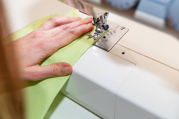woman working on a sewing machine - Fotó, kép