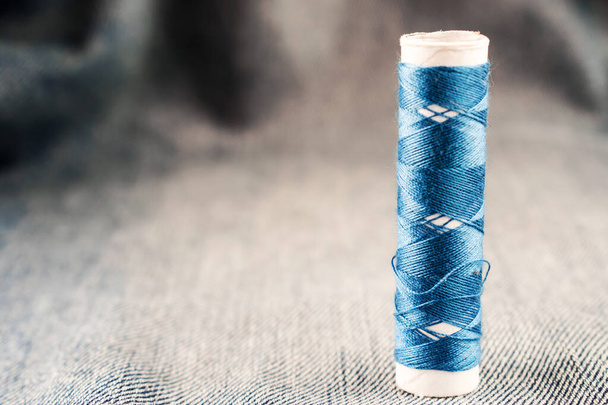 Threads on the background of jeans. Blue and red thread on the background of blue jeans. - Photo, Image