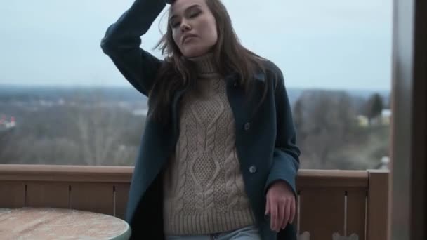 stylish thoughtful asian attractive young girl in blue coat, turtleneck outdoors - Footage, Video