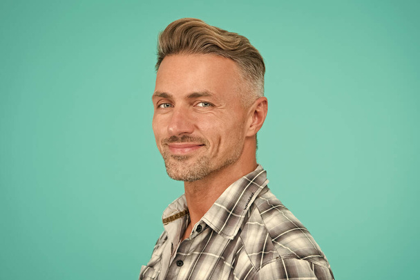 perfect male. portrait of real man. mature man unshaven face. smiling guy pleasant face. male skin and facial care. confident fashion model. barber salon services. sexy man turquoise background - Photo, Image