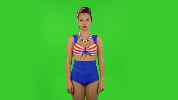 Beautiful girl in a swimsuit is making a rock gesture and enjoying life. Green screen - Felvétel, videó