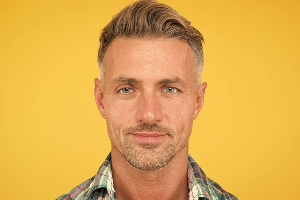 Male natural beauty. sexy man yellow background. portrait of real man. mature man unshaven face. smiling guy pleasant face. male skin and facial care. confident fashion model. barber salon services - Photo, Image