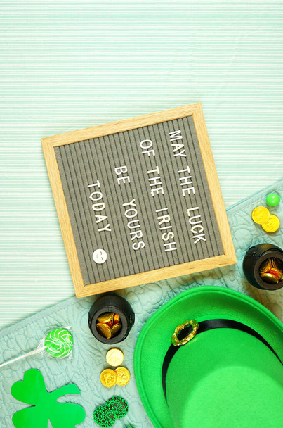St Patricks Day flatlay with leprechaun hat, chocolate coins, and letter board. - Φωτογραφία, εικόνα