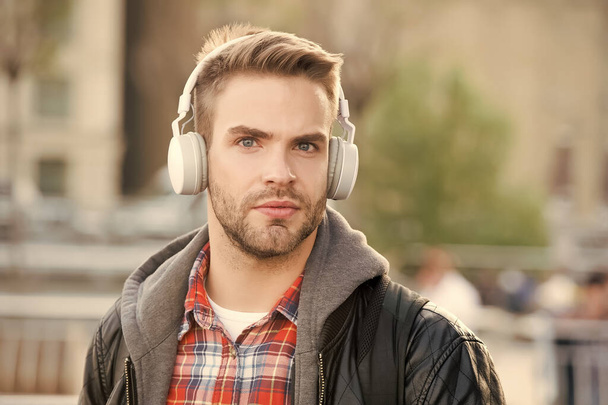 While walk. Online education courses. Listen music. Ebook audio concept. Student study use headphones. Handsome man urban background defocused. Distance education. Remote studying. Modern education - Photo, Image