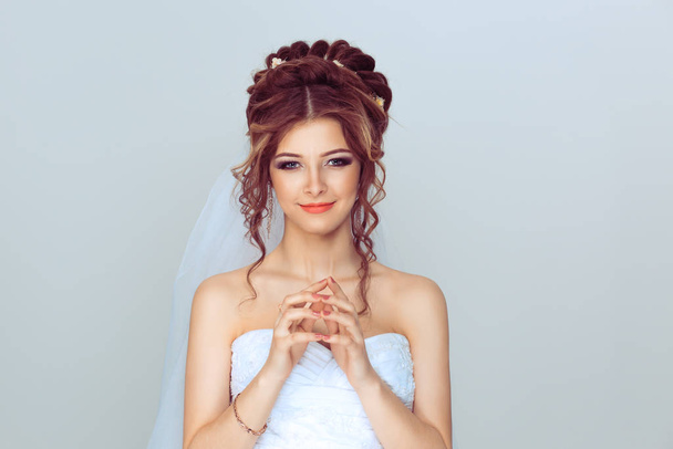Bride plotting. Closeup portrait sneaky, sly, scheming young woman plotting revenge plan, prankster isolated on light blue wall background. Negative emotion facial expression feelings body language - Photo, Image
