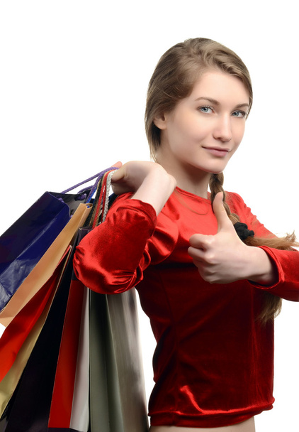 Young woman carrying many shopping bags, thumbs up. - Foto, afbeelding